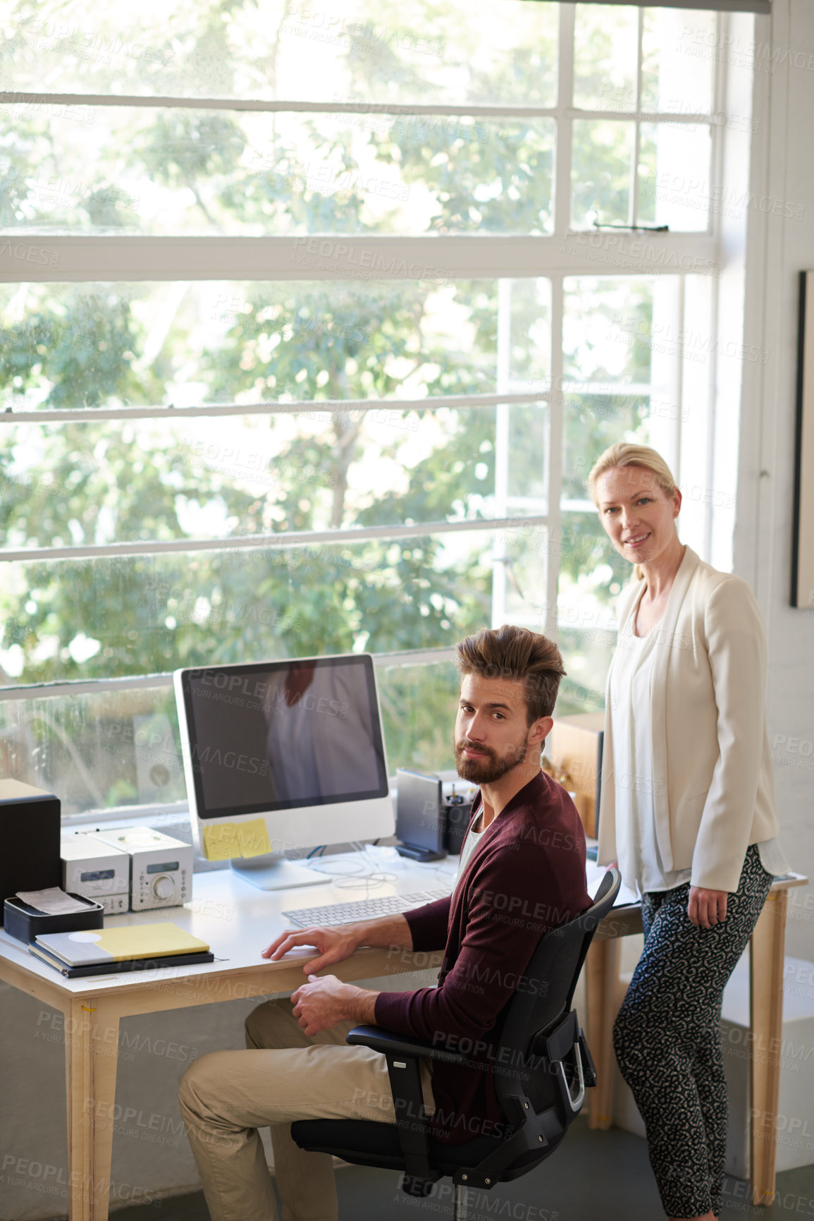 Buy stock photo Colleagues in a creative space looking positively at the camera
