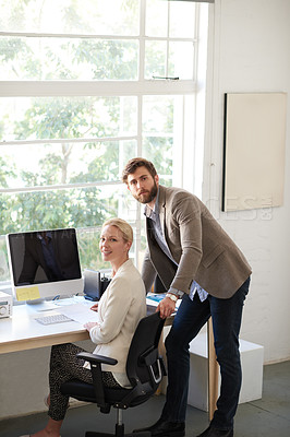 Buy stock photo Male and female colleagues in a bright office space looking at the camera
