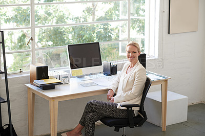 Buy stock photo Confident businesswoman looking positively at the camera in her bright office space
