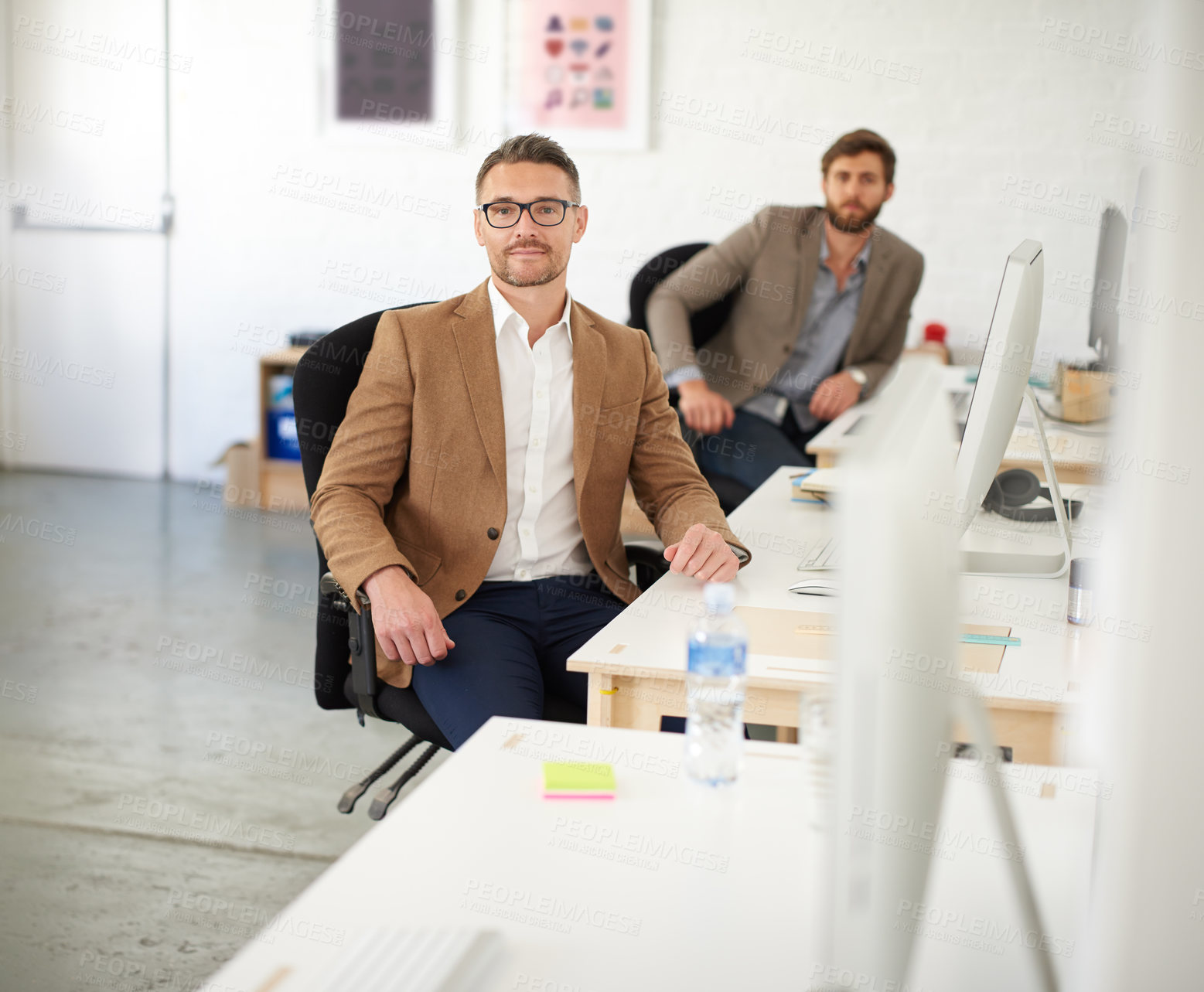 Buy stock photo Businessman, glasses and portrait in office, serious and coworking of colleagues, computer and together. Face, working and entrepreneur in company, journalist and confidence in startup and creative