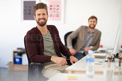 Buy stock photo Two male professionals smiling at the camera in a shared office