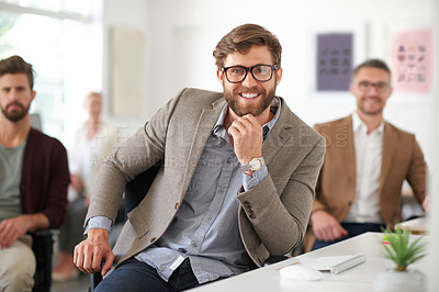 Buy stock photo Handsome young designer smiling at the camera in a shared office
