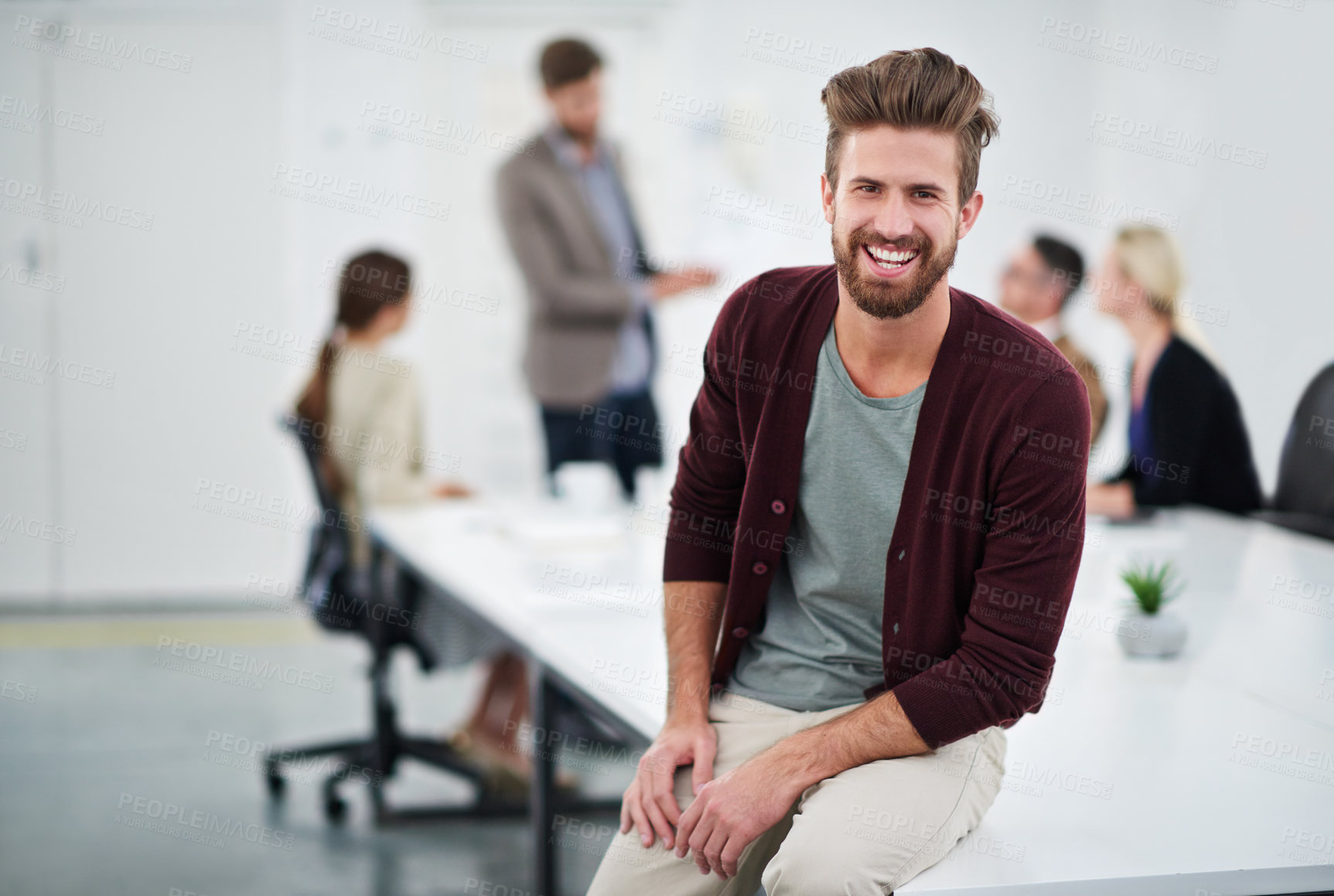 Buy stock photo Portrait of a young businessperson in a conference room with colleagues in the background