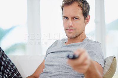 Buy stock photo Remote, man and portrait on sofa in living room for tv, entertainment and relax on break at home. Male person, pyjamas and couch with control for decision, choice and streaming movies in lounge