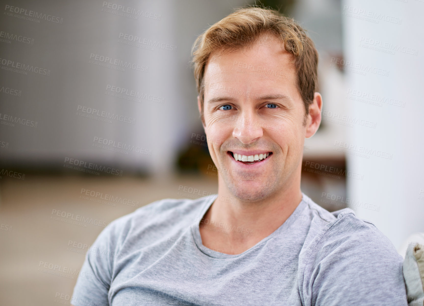 Buy stock photo Cropped shot of a handsome man relaxing at home