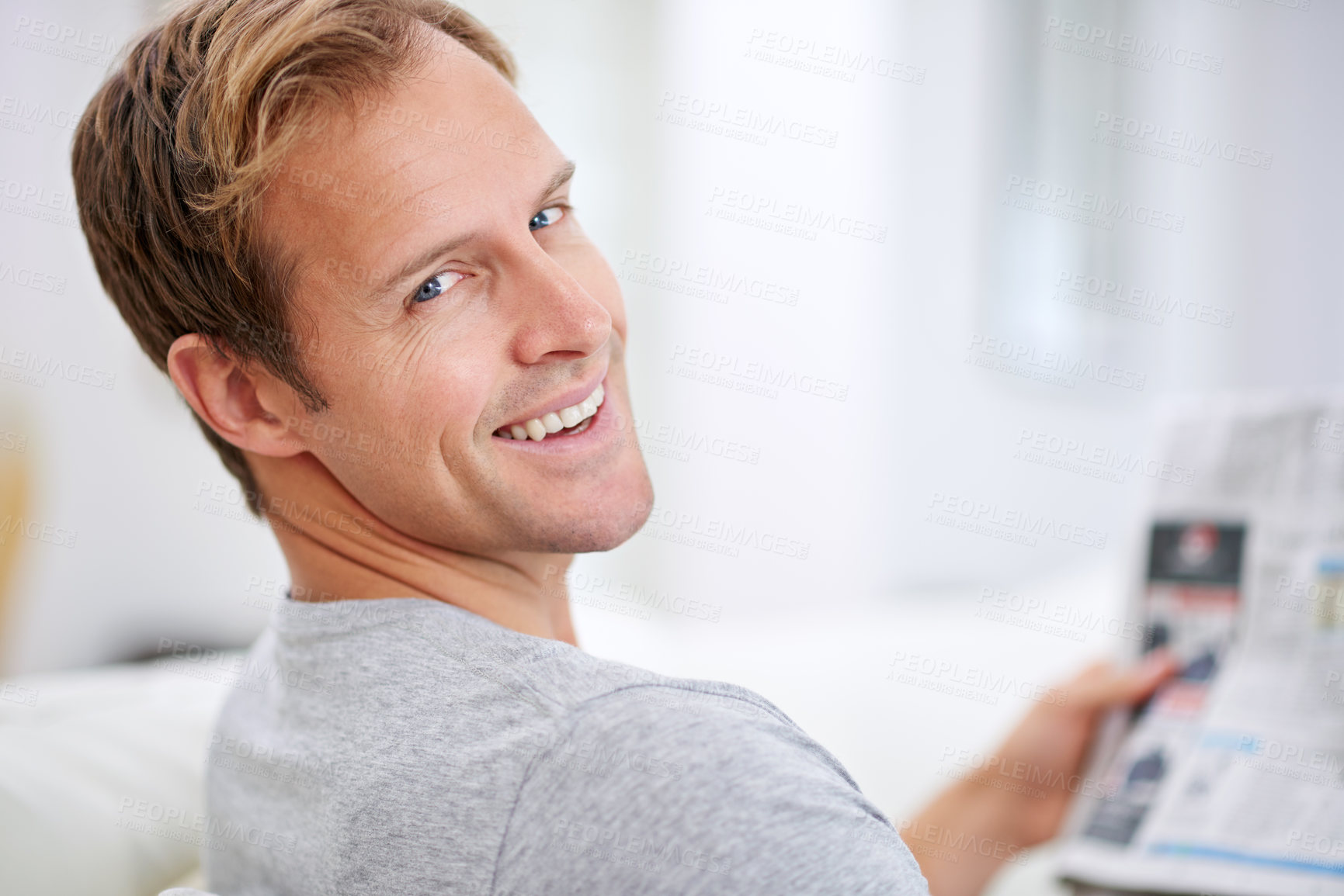 Buy stock photo Man, newspaper and article in home portrait, calm and comfortable on weekend in living room. Male person, reading and print in apartment, information and rest on couch in pyjamas for story update