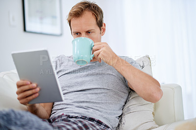 Buy stock photo Man, tablet and coffee in living room for morning, social media and watching movies on internet. Technology, reading and communication on couch for online streaming, email and blog in apartment