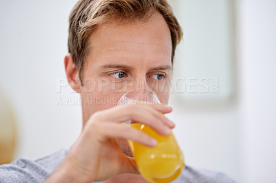 Buy stock photo Man, morning and drinking orange juice in home for vitamin c health or citrus beverage, breakfast or antioxidants. Male person, glass and wellness micronutrients in apartment, immune system or relax
