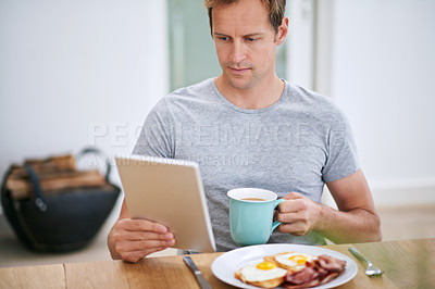 Buy stock photo Man, tablet and morning breakfast in home or nutrition meal with coffee, eggs or reading. Male person, relax and digital news in apartment kitchen with food or online article, streaming or connection