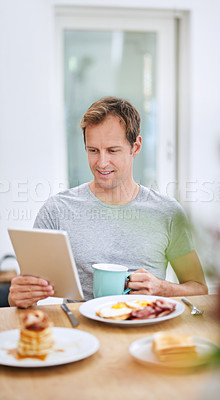 Buy stock photo Happy, man and breakfast with tablet at table for morning routine with entertainment on weekend at home. Smile, male person and tech for watching tv, streaming movies or social media on vacation