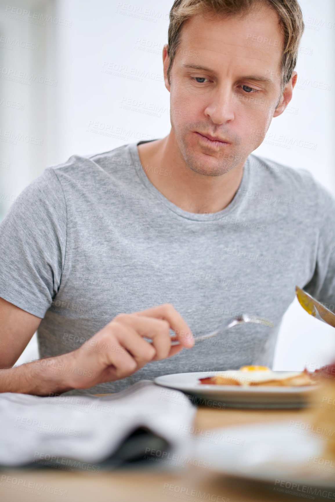 Buy stock photo Eat, newspaper and breakfast with man reading for current events in house at table in morning. Food, weekend and energy with boost for nutrition with entertainment or headline story in apartment 