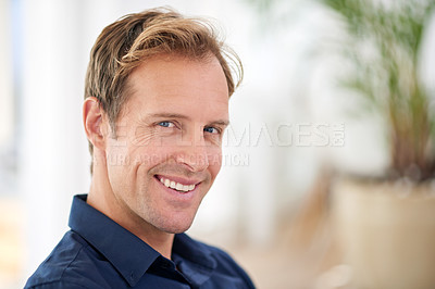 Buy stock photo Cropped portrait of a handsome man relaxing in his home
