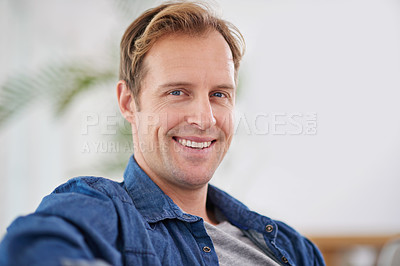 Buy stock photo Man, smile and relax in home portrait, calm and comfortable on weekend in living room. Happy male person, confidence and morning in apartment, health and wellness by resting on couch for peace