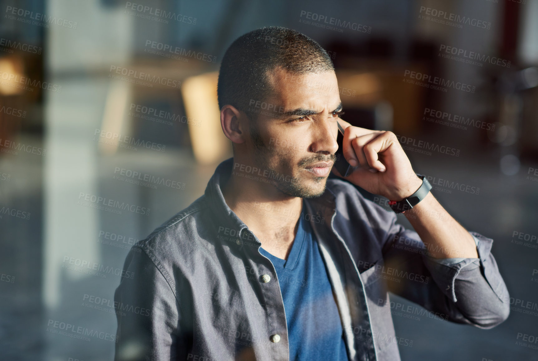 Buy stock photo Cropped shot of a young businessman talking on his mobile phone