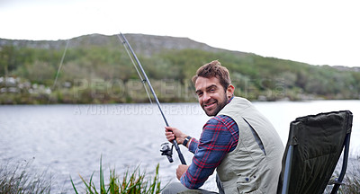 Buy stock photo Portrait of a handsome young man fishing by a lake