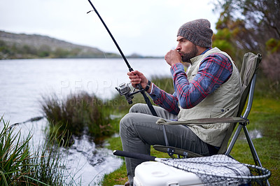 Buy stock photo Man, fishing rod and lake for camping and outdoor recreation on holiday trip for weekend in cold environment. Fisherman or male camper and sitting with patience by river with equipment on vacation