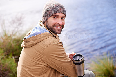 Buy stock photo Camping, smile and portrait of man with coffee by lake in nature for adventure, travel and outdoor vacation. Holiday, back view and male person with hot beverage for relax, peace and happiness
