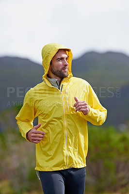 Buy stock photo Running, rain and man with exercise, training and endurance with progress and dedication with nature. Wet, runner and athlete with cardio and wellness with wind and breathing with fitness and workout