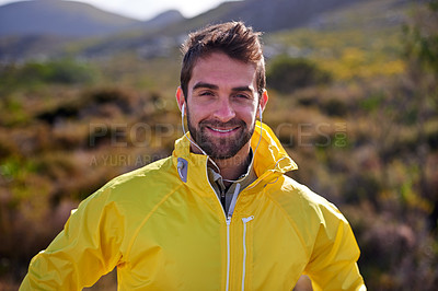 Buy stock photo Shot of a handsome young man in all weather gear posing in front of natural bush