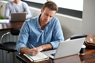 Buy stock photo Man, writing on book and laptop in modern office for information with project planning, email and internet research. Male programmer, coding language and learning on computer for software development