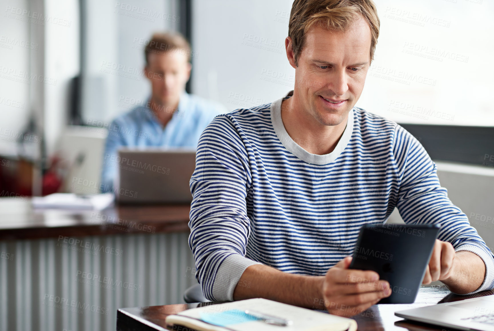Buy stock photo Desk, smile and businessman with tablet in office for communication, planning or checking email. Journalist, agency and man with technology at work for online news, information or research on article