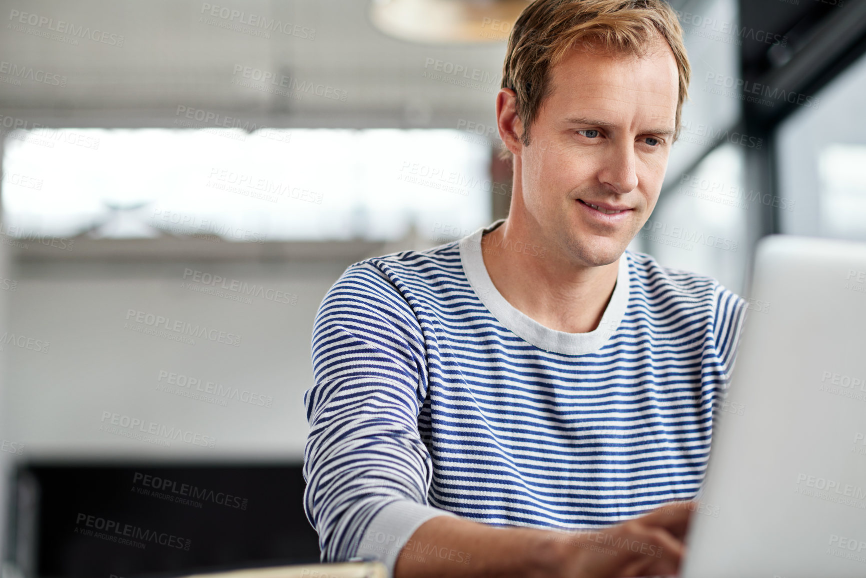 Buy stock photo Man, employee and happy in office with laptop on internet for research, ideas and information as graphic designer. Proud, smile and confident in startup company with creativity in digital agency