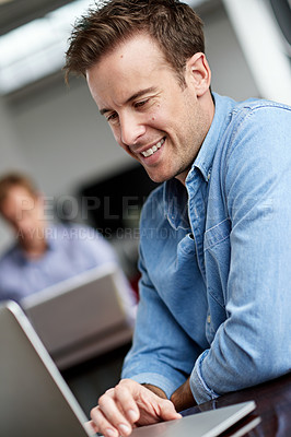 Buy stock photo Man, employee and happy in office with laptop on internet for research, ideas and information as website designer. Smile, confident and startup company or business for project in digital agency