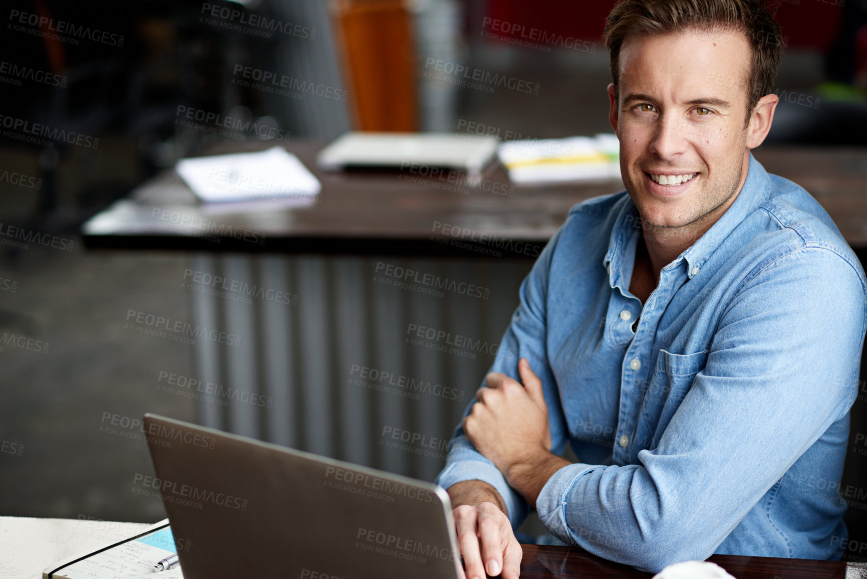 Buy stock photo Shot of a man working on a laptop in an office