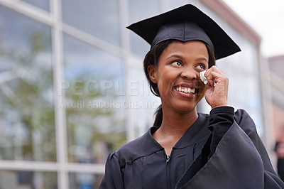Buy stock photo Portrait of a beautiful african student wiping away tears of joy on her graduation day