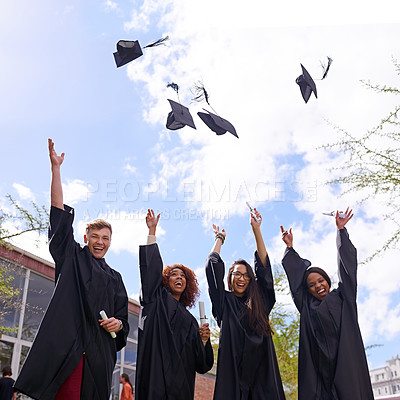 Buy stock photo Low angle shot of student throwing their graduation hats into the air