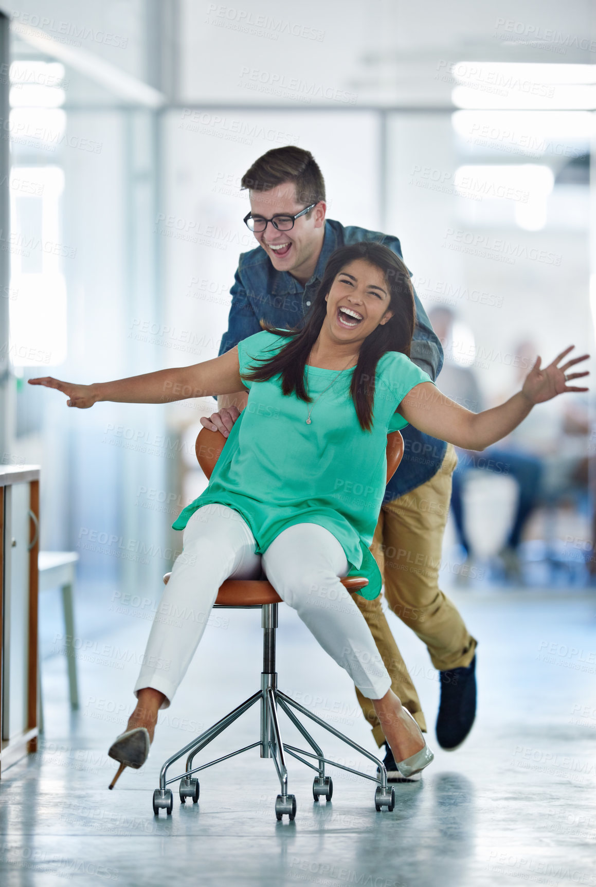 Buy stock photo Office, fun or business women push chair for happiness, investment growth or startup success in company workspace. Friends, celebration and people with excited face for playing, achievement and win