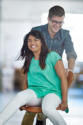 Buy stock photo Office, smile or business women push chair for happiness, investment growth or startup success in company workspace. Friends, celebration and people with excited face for playing, achievement and win