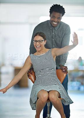 Buy stock photo Office, celebration or business women push chair for happiness, investment growth or startup success in company workspace. Diversity, fun and people with excited face for playing, achievement and win
