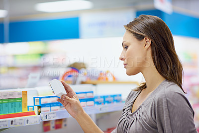 Buy stock photo Pharmacy, shopping and woman checking box for healthcare, medical information or product price. Choice, decision and customer reading medicine label, ingredients and advice on pharmaceutical drugs