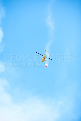 Buy stock photo Smoke, water and helicopter in sky for emergency, disaster management and firefighter service. Fire, damage control and chopper in flight with bucket, spray or rescue volunteer in nature conservation