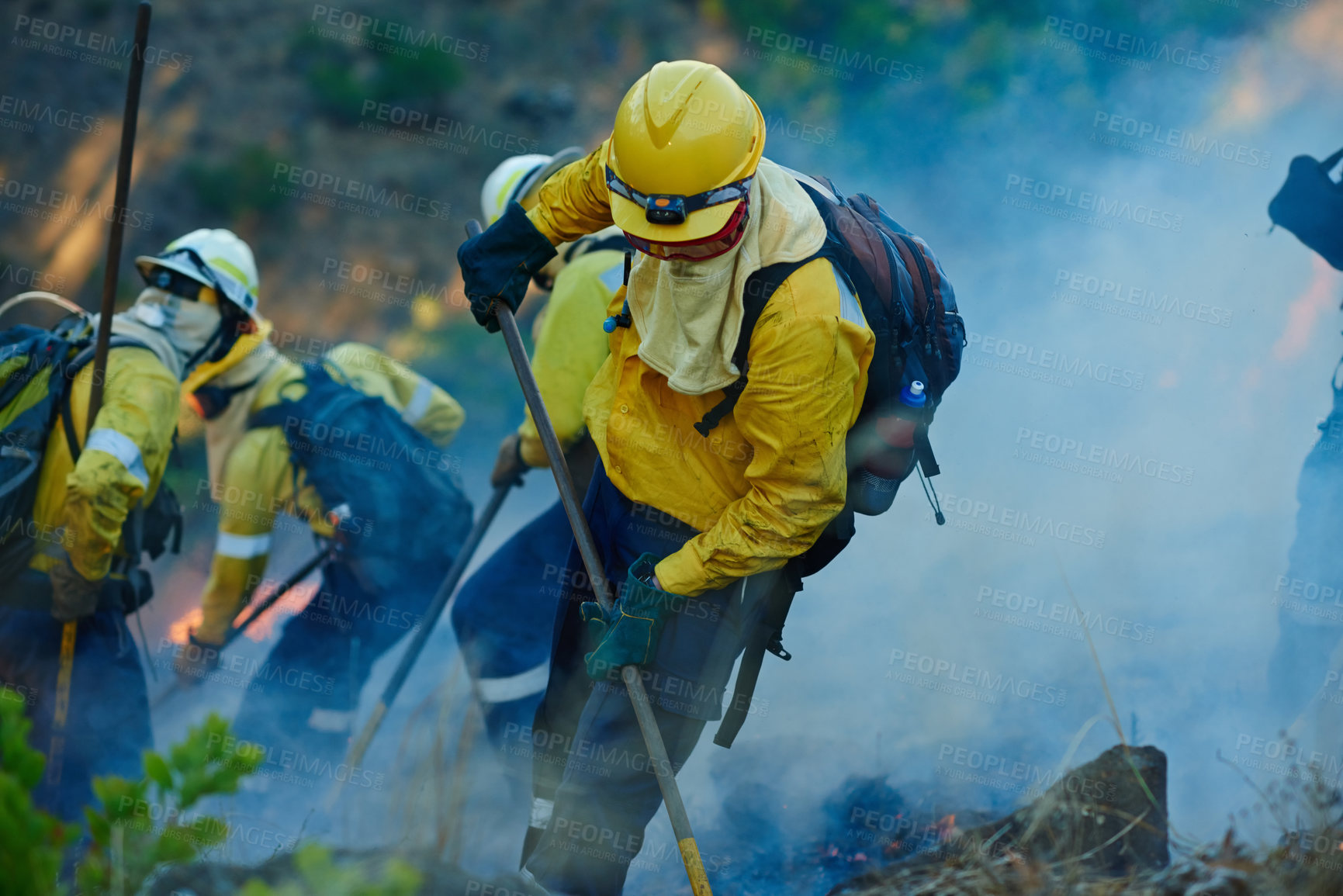 Buy stock photo Emergency, forest and firefighter team with disaster management, smoke and damage control in bush. Mountain, flame and people help with fire rescue, volunteer service or safety in nature conservation