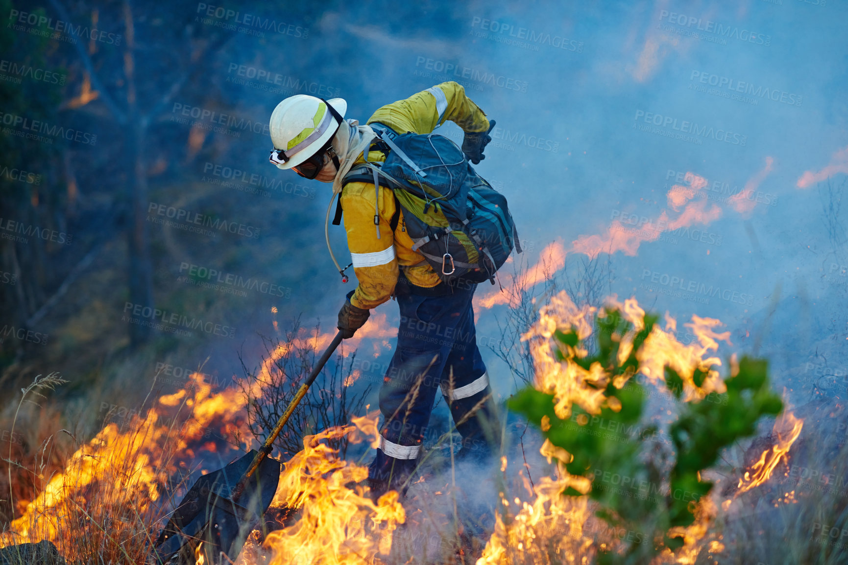 Buy stock photo Smoke, flame and firefighter in forest for emergency, disaster management and damage control in bush. Mountain, help and man with fire rescue, volunteer service and courage for nature conservation