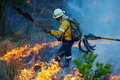 Buy stock photo Courage, flame and firefighter in forest for emergency, disaster management and damage control in bush. Mountain, help and man with smoke, fire rescue and volunteer service for nature conservation