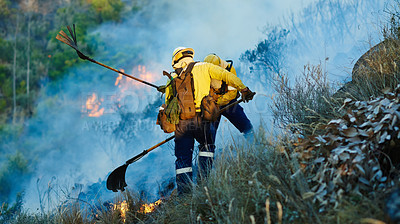 Buy stock photo Smoke, field and firefighter team in forest for emergency, disaster management or damage control in bush. Mountain, flame and people help with fire, volunteer service or safety in nature conservation