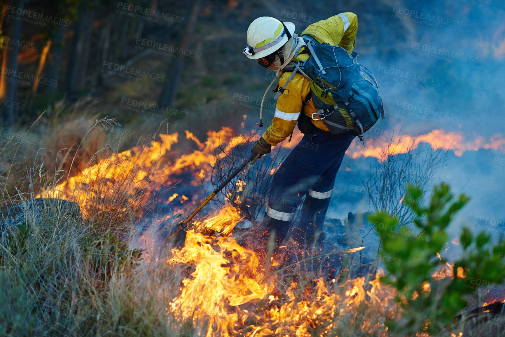 Buy stock photo Smoke, fire and man in forest for emergency, disaster management and damage control in bush. Mountain, help and firefighter in flame for rescue, volunteer service and courage for nature conservation