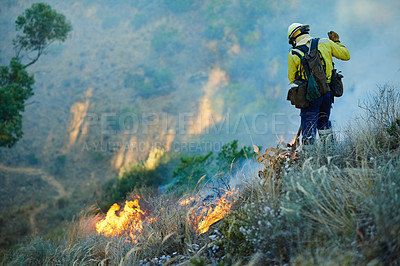 Buy stock photo Courage, flame and firefighter in forest for emergency, disaster management and damage control in bush. Mountain, help and man in smoke for fire rescue, volunteer service or nature conservation