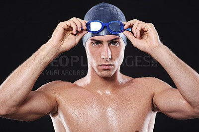 Buy stock photo Man, studio and portrait or swimmer with goggles, workout and exercise with athlete for cardio health. Wellness, confident and male person with swimming cap, isolated on black background for sport