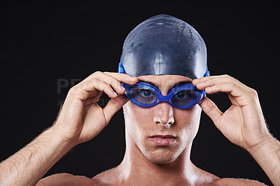 Buy stock photo Man, studio and portrait with swimming goggles, workout and exercise with athlete for cardio health. Wellness, confident and male person with swimmer cap, isolated on black background for sport
