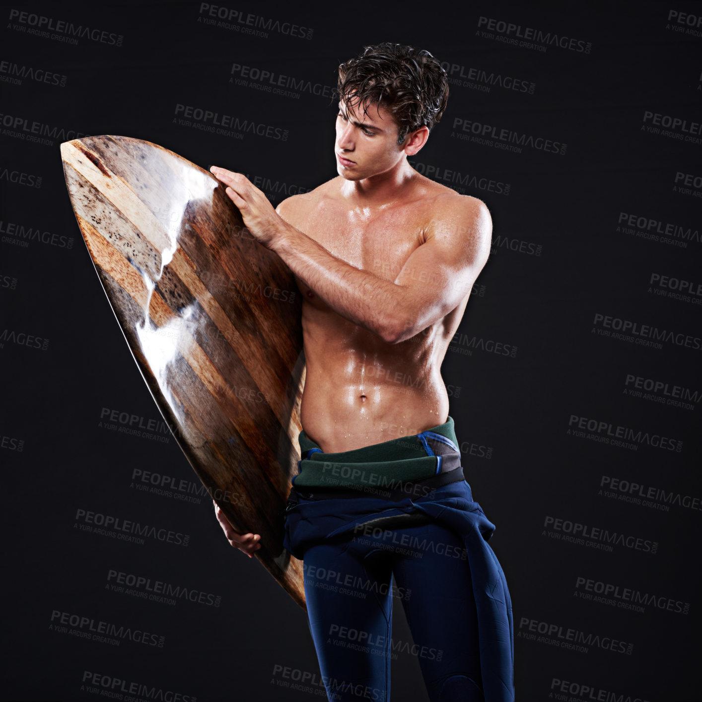 Buy stock photo Studio, surfboard and male surfer, athlete and wetsuit isolated on black background. Body, swimsuit and water sports for man model, equipment and wooden for cardio fitness or hobby for exercise