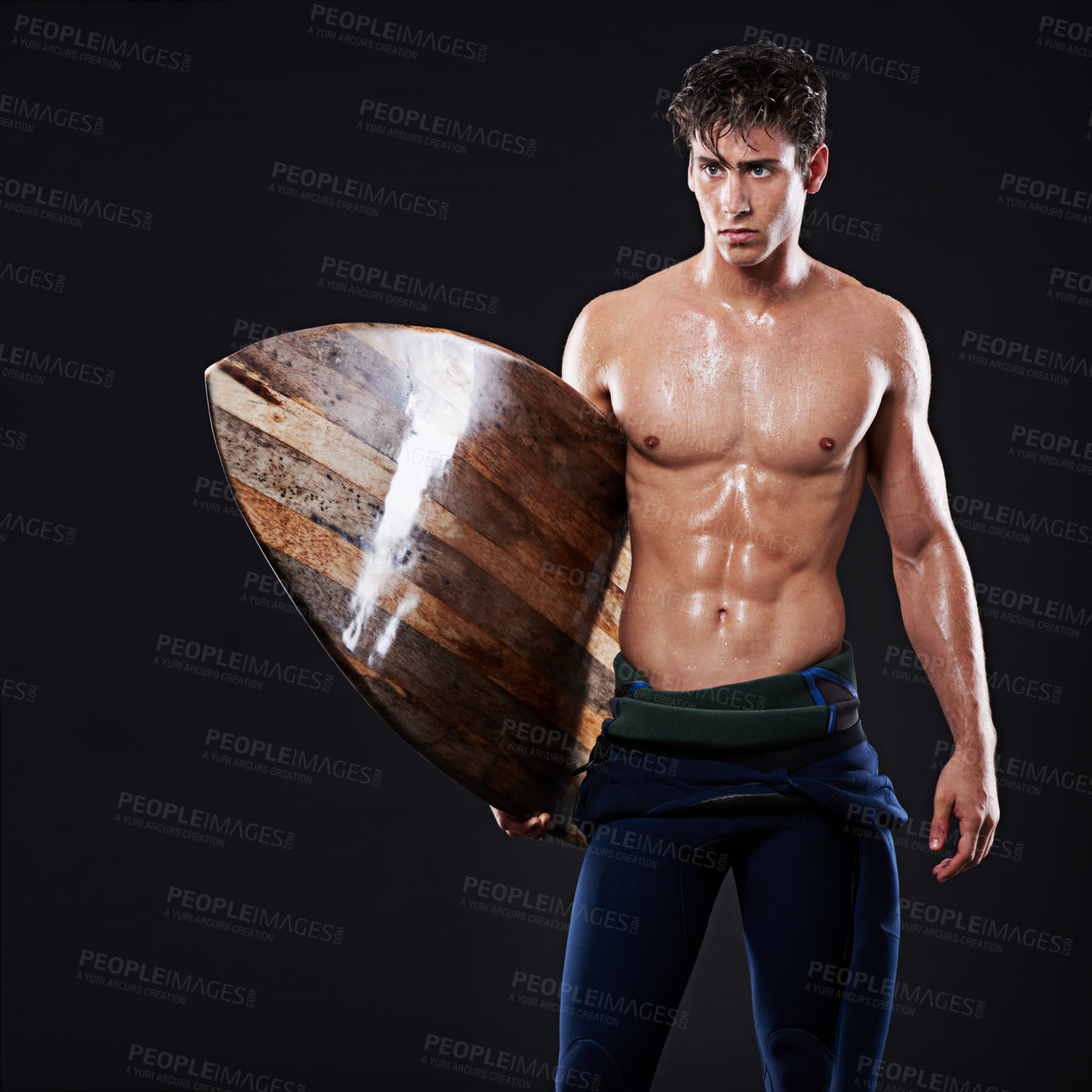 Buy stock photo Studio, surfboard and male surfer, athlete and wetsuit on black background. Body, swimsuit and water sports for man model with abs, wooden equipment and sweat for cardio fitness or fun hobby exercise