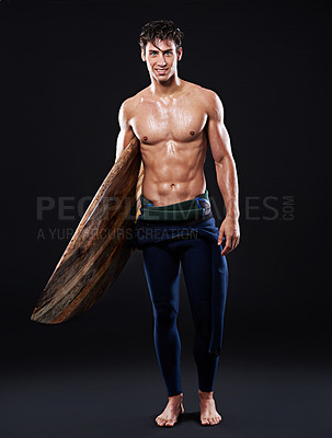 Buy stock photo Young surfer and vintage board in studio and dark with body, stomach and strong or healthy. Male wave rider, backdrop or wood or retro accessory in portrait for sports, fitness or confidence at night