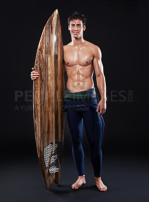 Buy stock photo Surfboard, athlete and male surfer in studio, wetsuit and portrait isolated on background. Body, smile and swimsuit for water sports for man model person, equipment and wooden for fitness or hobby