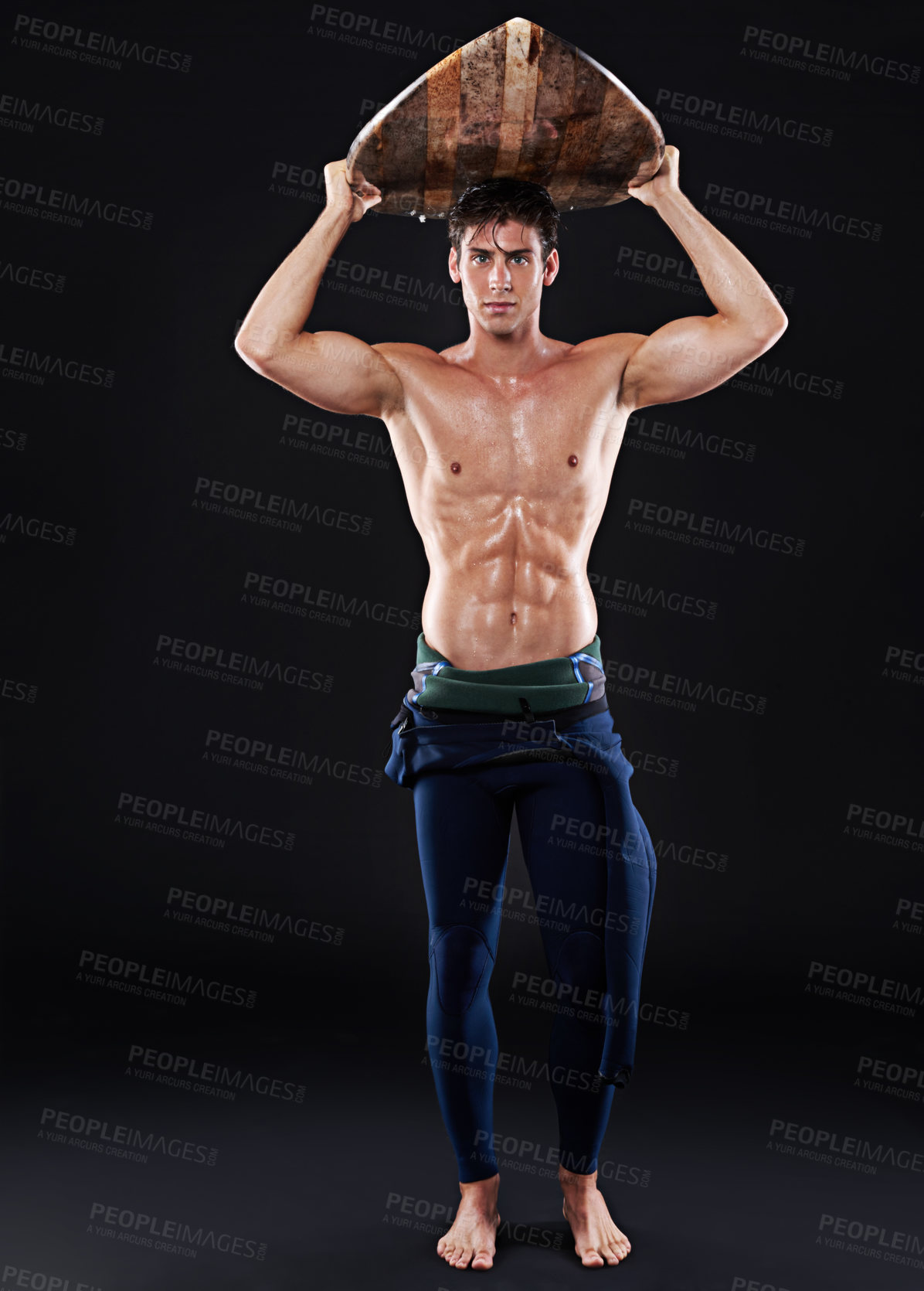 Buy stock photo Full length studio shot of a young surfer with a vintage board