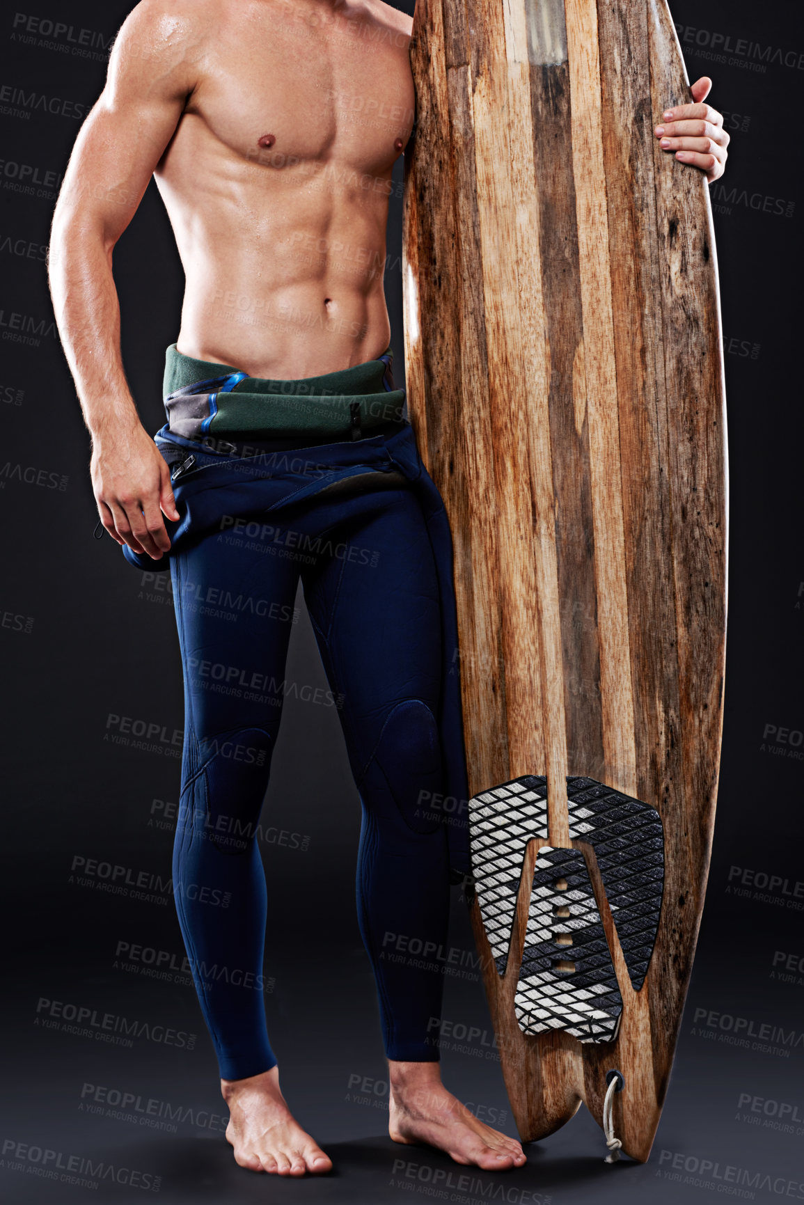 Buy stock photo Studio, surfboard and body of male surfer, wetsuit and  athlete isolated on black background. Training, swimsuit and water sports for man model person, equipment and wooden gear for fitness or hobby