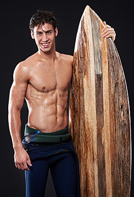 Buy stock photo Male surfer and vintage board in studio and dark with body, stomach and strong or healthy. Young wave rider, backdrop or wood or retro accessory in portrait for sports, fitness or confidence at night